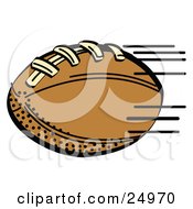 Fast Brown Leather American Football Speeding Through The Air During A Game