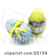 Two Decorated Blue And Yellow Easter Eggs With Yellow And Silver Bows