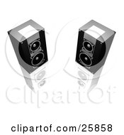 Two Black And Silver Stereo Speakers Facing Slightly Towards Each Other On A Reflective White Surface