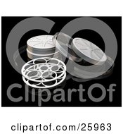 Open Movie Film Reel And Cases Over A Reflective Black Surface