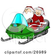 Santa Claus And Mrs Claus Riding A Green Snowmobile Through The Snow At The North Pole