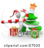 White Person Wearing A Santa Hat And Dancing With A Candy Cane In Front Of A Christmas Tree And Presents