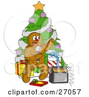 Festive Gingerbread Man Standing In Front Of A Christmas Tree With Gifts Singing Karaoke