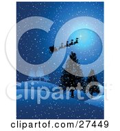 Clipart Illustration Of Silhouetted Reindeer Santa And His Sleigh Flying In The Moon Light Of A Snowy Winter Night Of Christmas Eve by KJ Pargeter