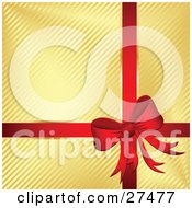 Red Bow And Ribbon Adorning A Gift Wrapped In Golden Striped Paper