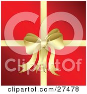 Golden Bow And Ribbon Adorning A Christmas Present Wrapped In Red Paper
