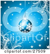 Poster, Art Print Of Blue Christmas Ornament With White Snowflake Patterns Suspended Over A Bursting Blue Background With Grasses And Stars