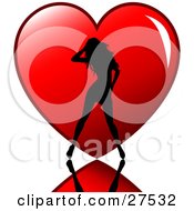 Sexy Silhouetted Woman Standing On A Reflective Surface In Front Of A Big Red Heart