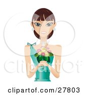 Beautiful Brunette Caucasian Woman In A Green Evening Gown Wearing Diamond Earrings And A Necklace Smiling And Holding A Bouquet Of Flowers