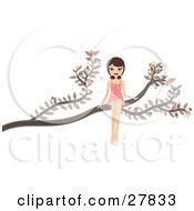 Happy Brunette Caucasian Woman In A Pink Polka Dot Dress Sitting Out On A Tree Branch