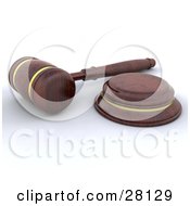 Wooden Judge Or Auctioneer Gavel Resting On A White Surface
