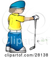 Man In A Yellow Shirt And Blue Hat Standing In Front Of A Golf Ball And Resting His Hand On A Club