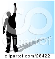 Poster, Art Print Of Black Silhouetted Successful Man Holding His Fist Up In The Air Over A Gradient Blue Background