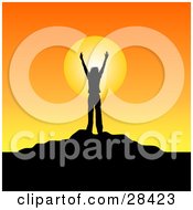 Poster, Art Print Of Silhouetted Person Standing With Their Arms In The Air On Top Of A Hill Against An Orange Sunrise Or Sunset