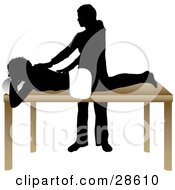 Poster, Art Print Of Silhouetted Masseuse Massaging A Clients Back In A Spa