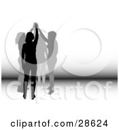 Clipart Illustration Of A Group Of Four Silhouetted Women Holding Their Hands Up Together Symbolizing Teamwork And Friendship