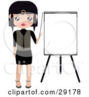 Black Haired Woman Pointing To A Blank Easel Board During A Presentation