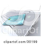 Clipart Illustration Of A Blue Credit Card Resting On Top Of A White Laptop Keyboard