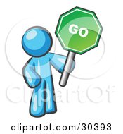 Poster, Art Print Of Light Blue Man Holding Up A Green Go Sign On A White Background
