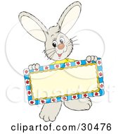 Poster, Art Print Of Friendly Little Rabbit Holding A Blank Sign