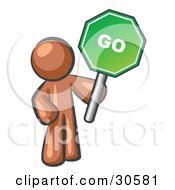 Brown Man Holding Up A Green Go Sign On A White Background