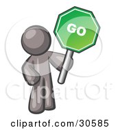 Poster, Art Print Of Gray Man Holding Up A Green Go Sign On A White Background