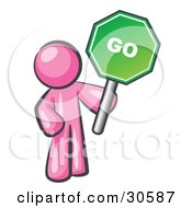 Pink Man Holding Up A Green Go Sign On A White Background