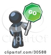 Navy Blue Man Holding Up A Green Go Sign On A White Background