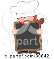 Male Chef With A Mustache Wearing A Hat And Holding A Wood Spoon While Pointing To A Blank White Chalkboard