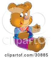 Bear Cub Wearing Clothing Sitting On The Floor And Smiling