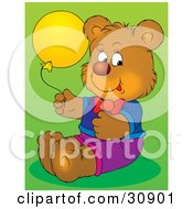 Clipart Illustration Of A Happy Brown Birthday Bear Dressed In Clothes Holding A Yellow Party Balloon Over A Green Background