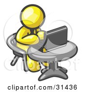 Clipart Illustration Of A Yellow Man Working On A Laptop Computer On A Table