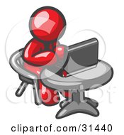 Clipart Illustration Of A Red Man Working On A Laptop Computer On A Table
