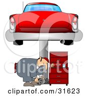 Poster, Art Print Of Male Mechanic Bending Over To Lift A Part While Working Under A Red Classic Car On A Lift In A Garage