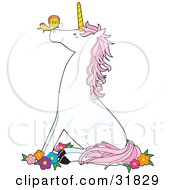 Clipart Illustration Of A Cute White Unicorn With A Golden Horn And Pink Hair Sitting On Its Hind Legs In Flowers And Watching A Butterfly On Its Nose by Maria Bell