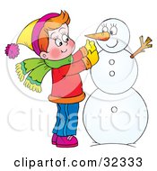 Poster, Art Print Of Happy Boy Putting A Carrot On His Snowman