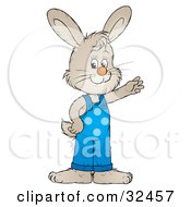 Clipart Illustration Of A Friendly Gray Bunny In Blue Overalls Waving
