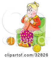 Happy Grandmother Sitting In A Green Chair And Knitting