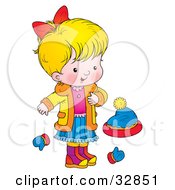 Blond Girl In A Coat Standing By Mittens And A Hat