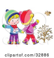 Little Boy And Girl Walking Holding Hands And Waving To A Bird On A Winter Day