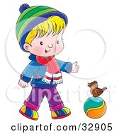 Boy In Winter Clothes Talking To A Bird On A Ball