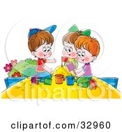 Girl And Two Boys Playing In A Sand Box