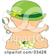 Baby In A Hat And Shamrock Diaper Holding A Rattle And Having Fun On St Patricks Day