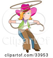 Teenage Cowgirl In Chaps And A Pink Hat Swinging A Lasso