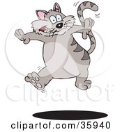 Clipart Illustration Of A Hyperactive Gray Striped Cat Leaping Up Over A Shadow