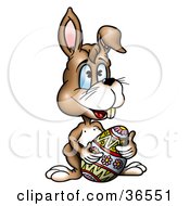 Clipart Illustration Of A Happy Brown Bunny Rabbit Resting With A Colorful Easter Egg