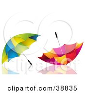 Poster, Art Print Of Two Green Yellow And Blue And Red Pink And Yellow Umbrellas On A Reflective White Surface