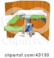 Plumber Kneeling To Work On Pipes Under A Sink