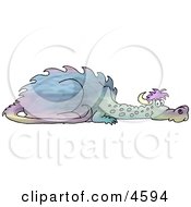 Young Mythical Dragon Laying On The Ground Clipart