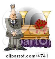 Male Funeral Director Standing Beside A Casket